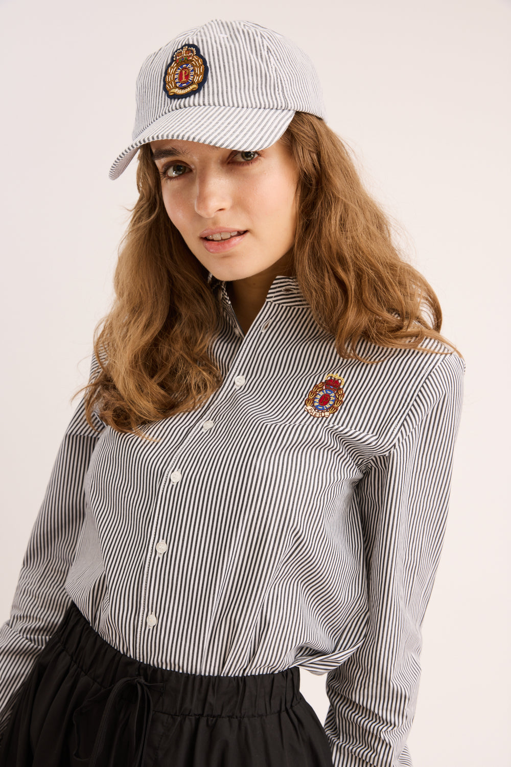Model wearing the Signature Striped Poplin Shirt with a popling skirt.