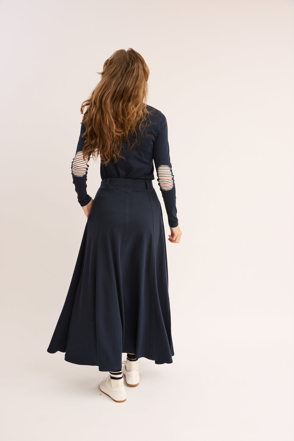 Model showing the back of. the Pima Paneled Skirt.