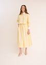 Woman wearing the yellow Cropped Poplin Contrast Collar Shirt with matching skirt.