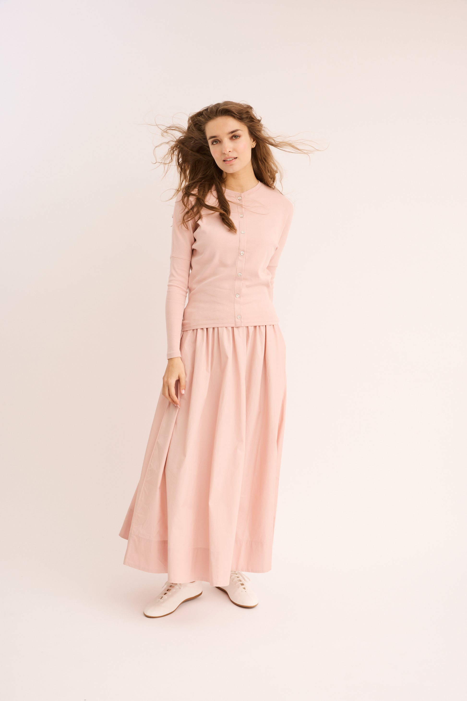 Woman wearing the blush Rhinestone Mock Cardigan Dolman. 