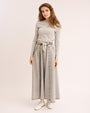Woman wearing the grey Classic Elbow Patch Tee with denim skirt. 