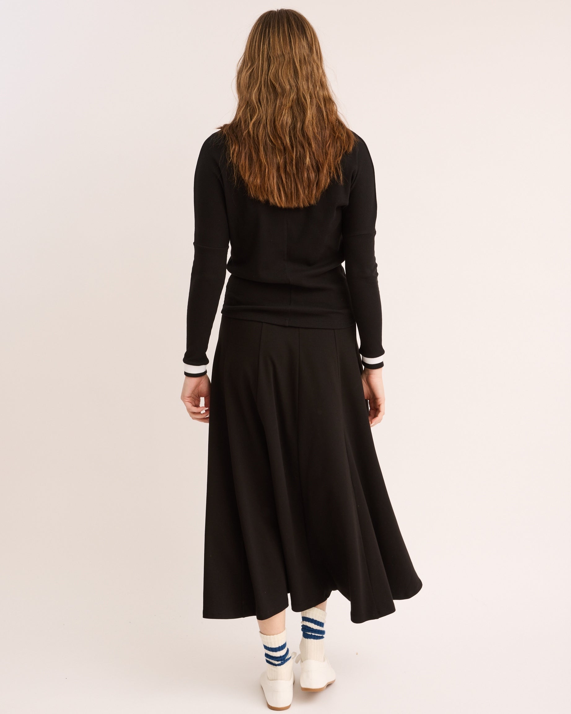 Model showing the back of the High Waisted Panel Skirt in Black.
