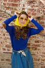 Woman wearing the royal blue Classic Elbow Patch Tee. 