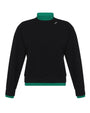 Black sweater with green trim on a white background