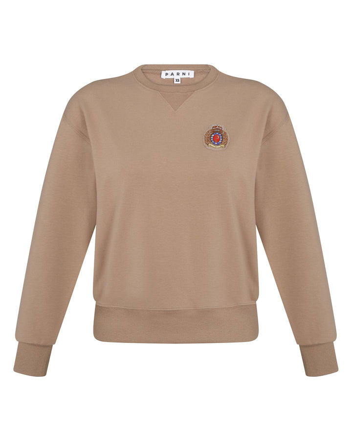 Camel color sweatshirt with emblem on white background.