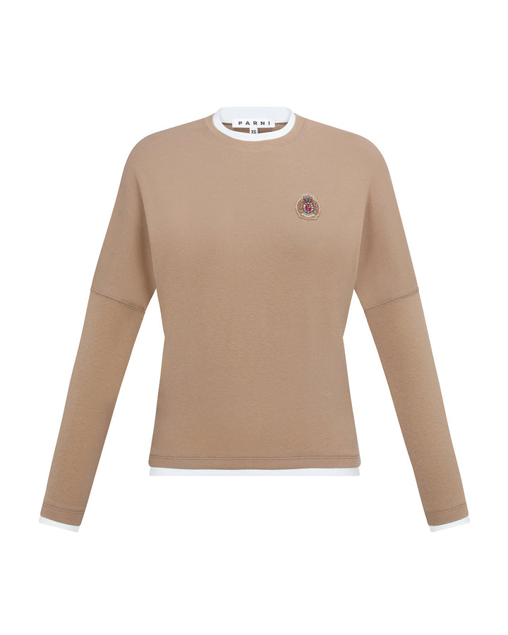 Beige long-sleeve shirt with a small logo on a white background