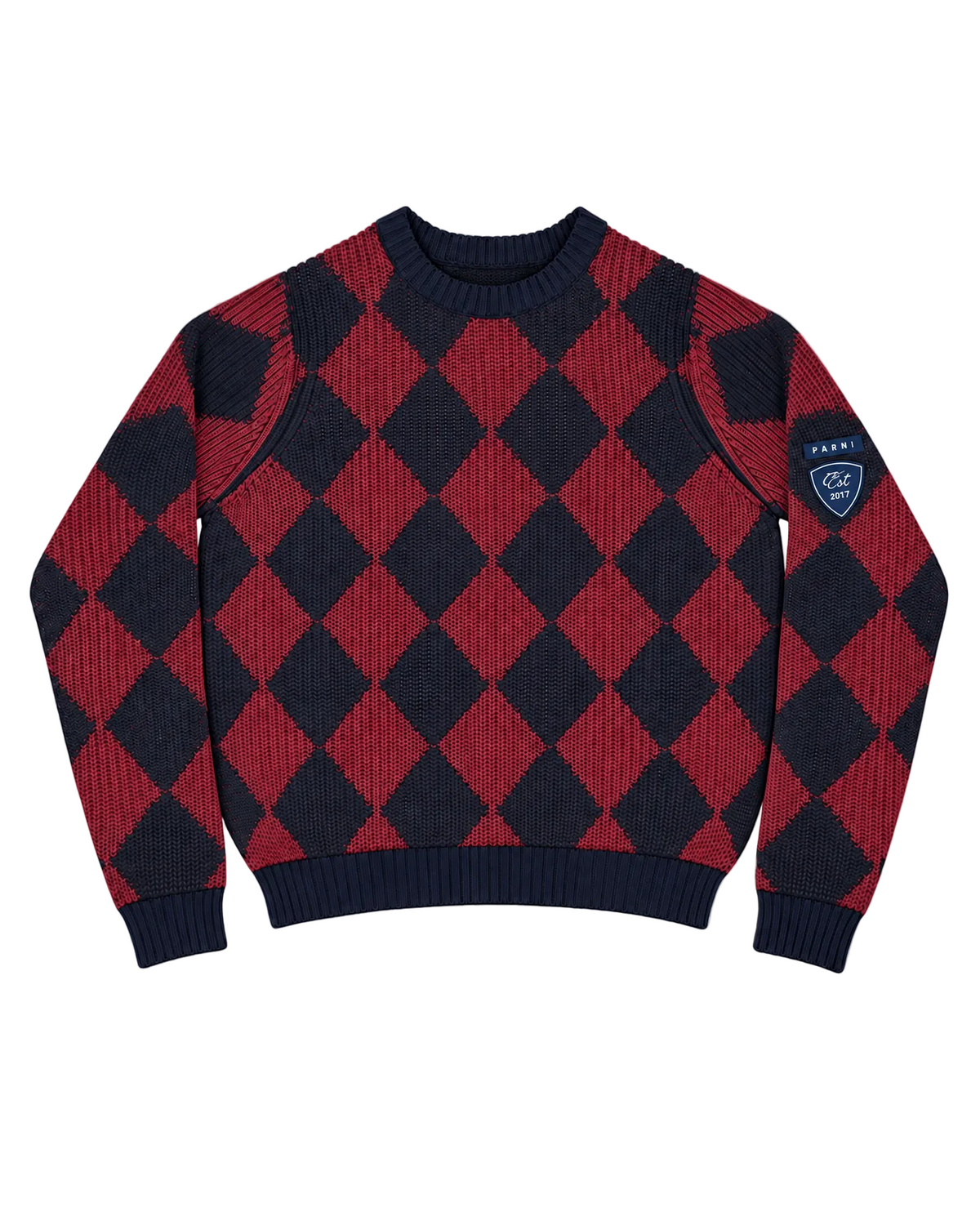 A long-sleeve crewneck sweater featuring a red and navy blue diamond argyle pattern, with a shield-shaped navy patch on the left sleeve that reads 'Parni'.