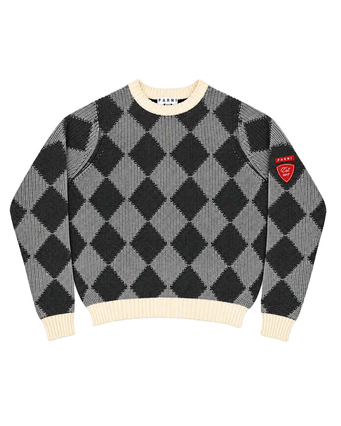 A knit crewneck sweater by A'NANI, featuring a black and gray argyle pattern with cream ribbed collar, cuffs, and hem, and a red shield patch on the left sleeve.