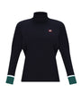 A women's long-sleeve turtleneck top in black, featuring a small red and white embroidered logo on the left chest and contrasting dark green cuffs with thin white stripes.