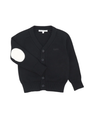 A black knit cardigan sweater with a V-neck, three-button front closure, raglan sleeves, and a contrasting white oval patch on one sleeve. The brand label 'L'Envers' is visible inside the collar.