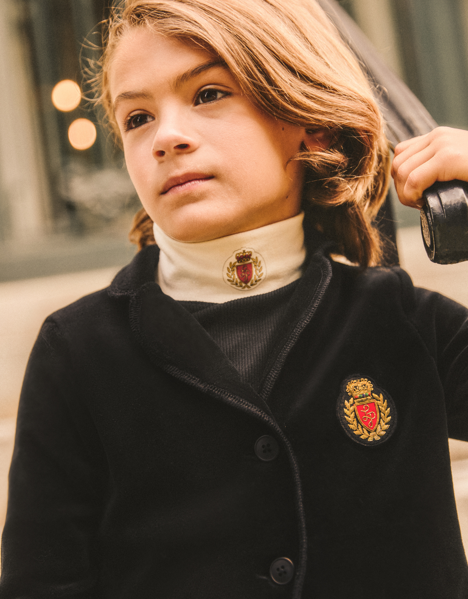 Boy wearing velvet blazer and turtlneck.