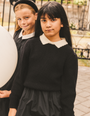 Girl wearing the Girls Collared Sweater in Black.