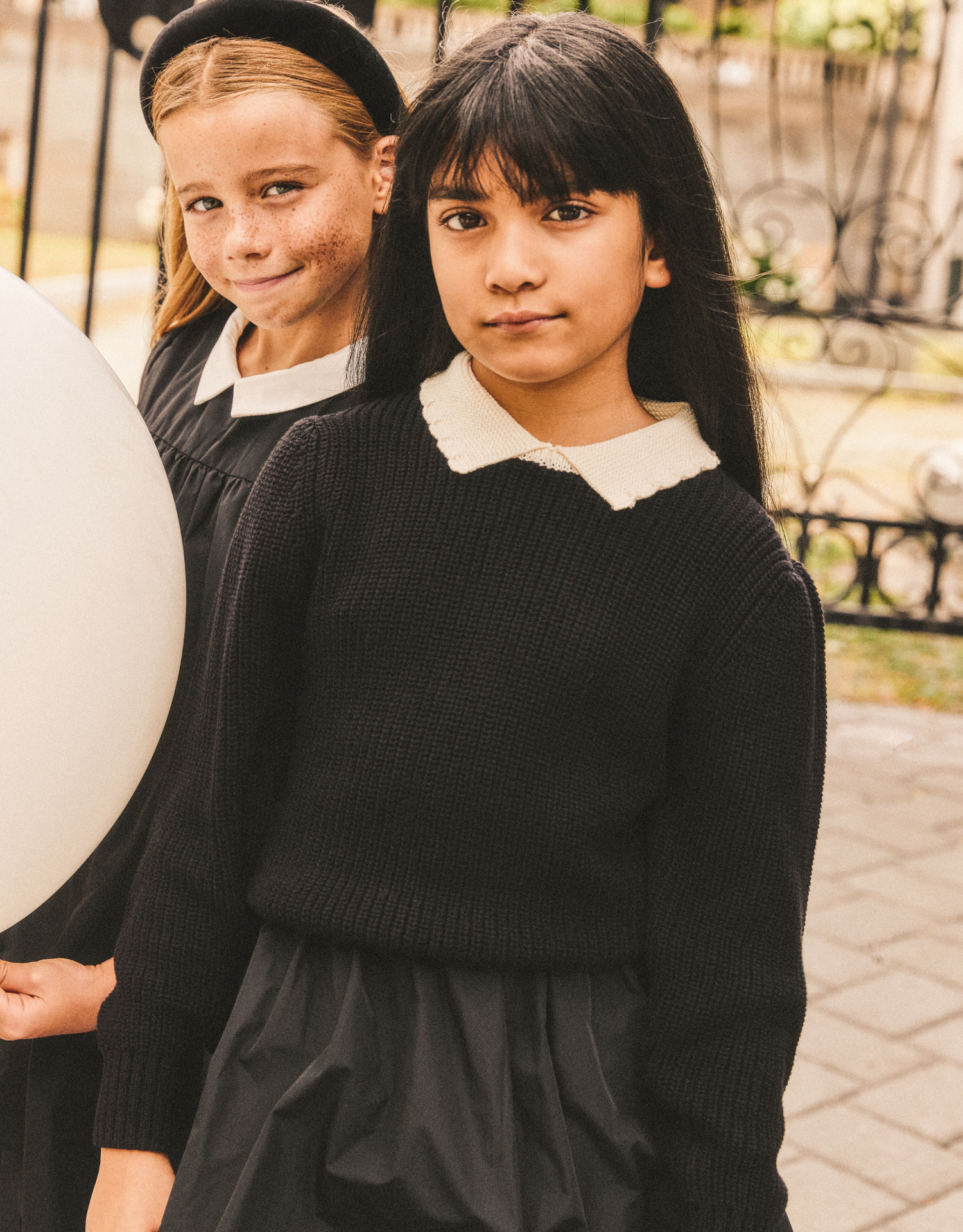 Girl wearing the Girls Collared Sweater in Black.