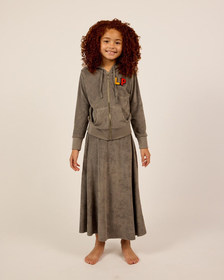 Model wearing the grey Girls French Terry Zip-Up Hoodie and Skirt Set.