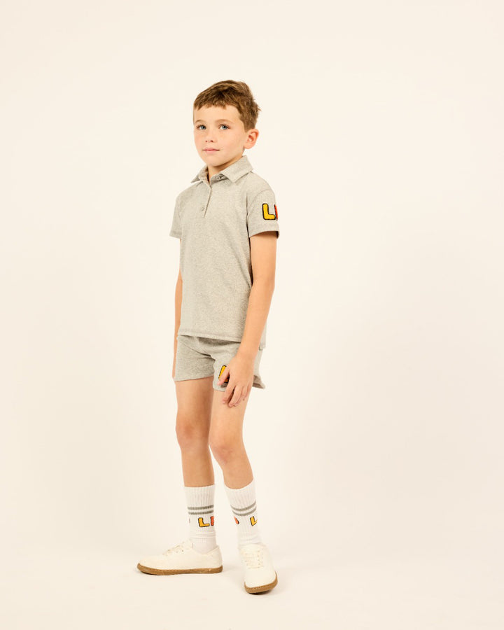 Boy wearing the grey LP Boys Varsity Short Sleeve Polo.