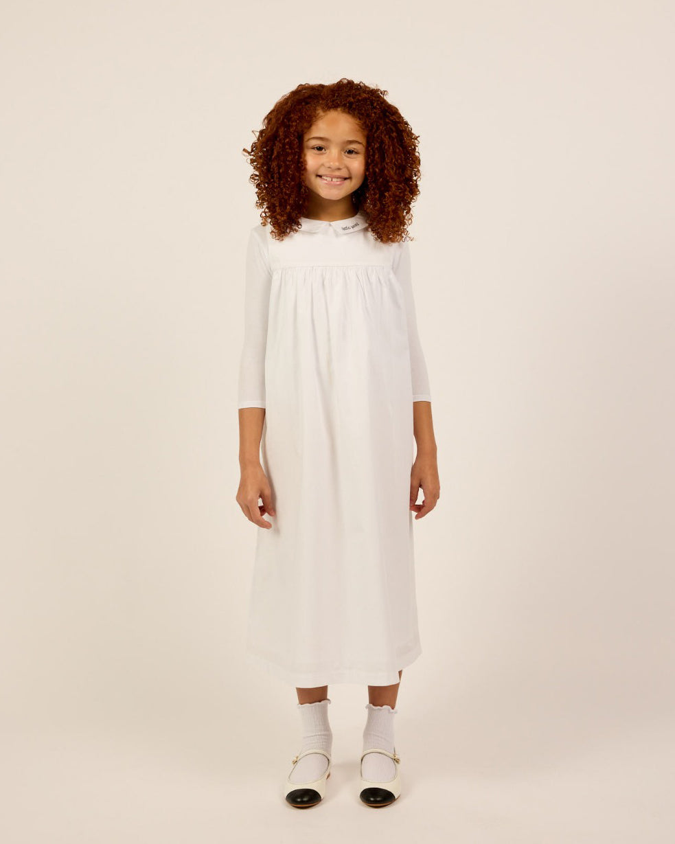 Girl wearing the Girls Sleeveless Collared Dress and T-Shirt Set in White.