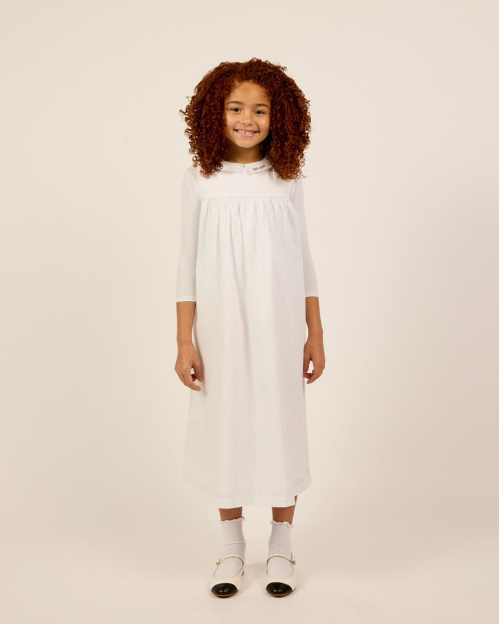 Girl wearing the Girls Sleeveless Collared Dress and T-Shirt Set in White.